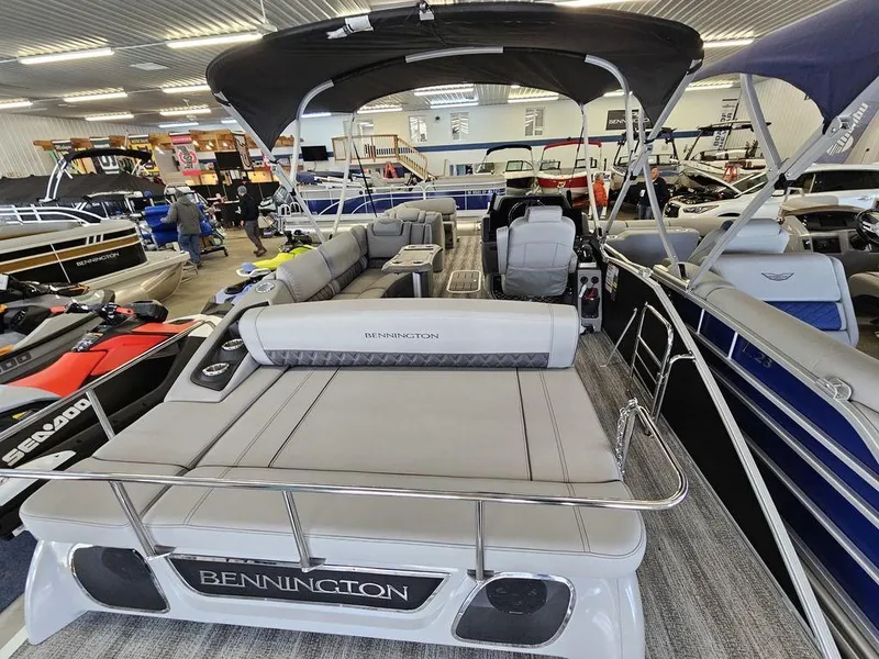 Slide: The Image of 2025 Bennington 23 RSB pontoon boat displayed in showroom. - 13