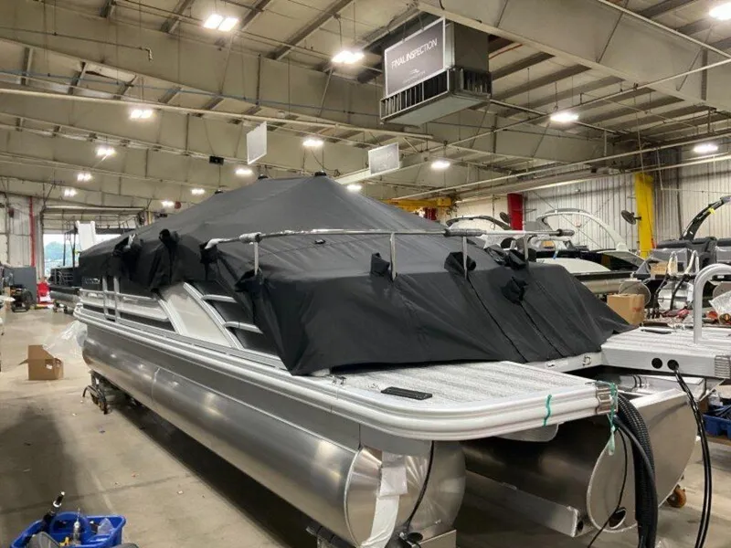 Slide: The Image of 2025 Bennington 23 RSB pontoon boat covered in a warehouse setting. - 20