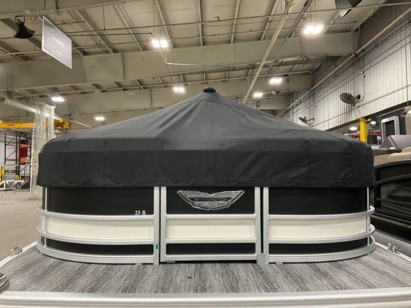 Slide: The Image of 2025 Bennington 23 RSB pontoon boat with cover in indoor showroom. - 23