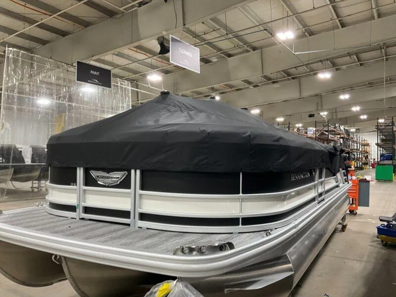 Slide: The Image of 2025 Bennington 23 RSB pontoon boat with cover in a showroom. - 24