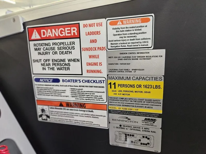 Slide: The Image of Warning labels on a 2025 Bennington 23 RSB boat, highlighting safety and capacity guidelines. - 25