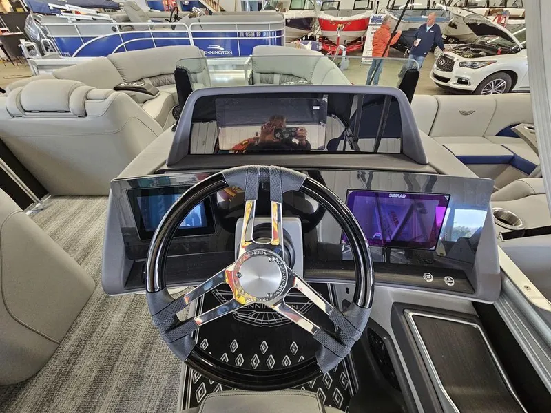 Slide: The Image of 2025 Bennington 23 RSB boat dashboard with modern steering wheel and digital displays. - 26