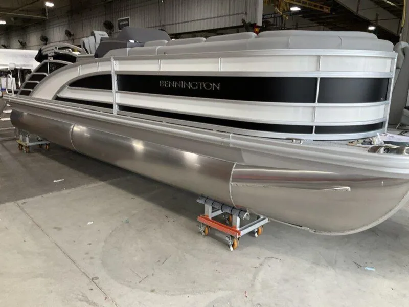 Slide: The Image of 2025 Bennington 23 RSB pontoon boat in a warehouse setting. - 3