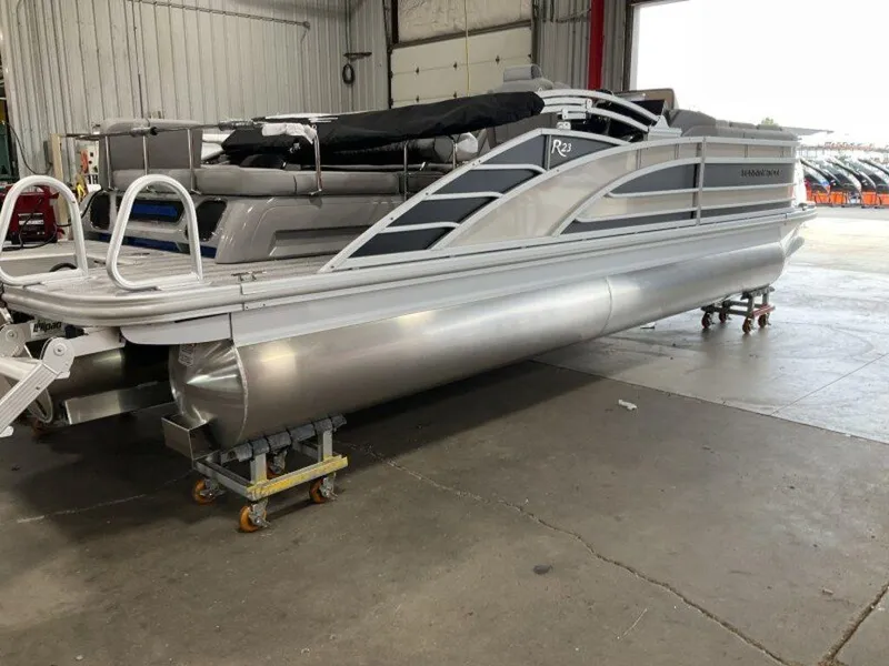 Slide: The Image of 2025 Bennington 23 RSB pontoon boat in a warehouse setting. - 4
