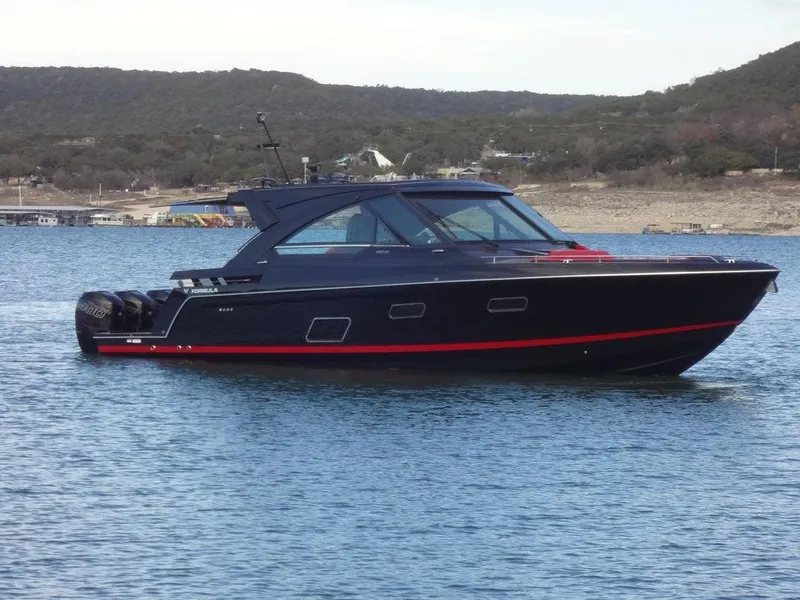 Slide: The Image of 2022 Formula 400 Super Sport Crossover boat on a lake with scenic background. - 1