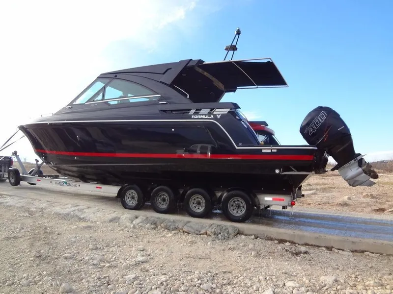Slide: The Image of 2022 Formula 400 Super Sport Crossover boat on trailer, black with red stripe. - 11