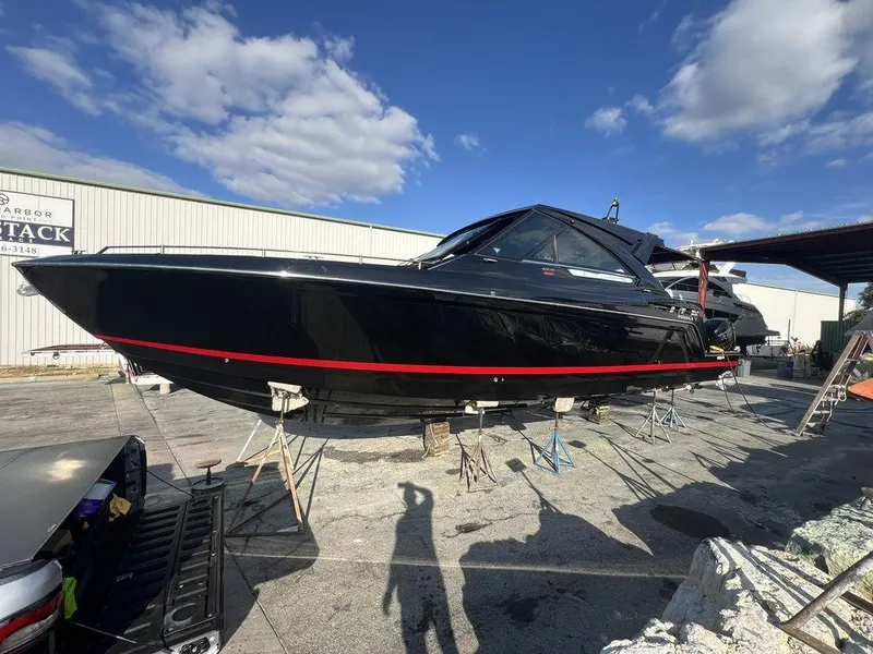 Slide: The Image of 2022 Formula 400 Super Sport Crossover boat on dry dock under blue sky. - 13