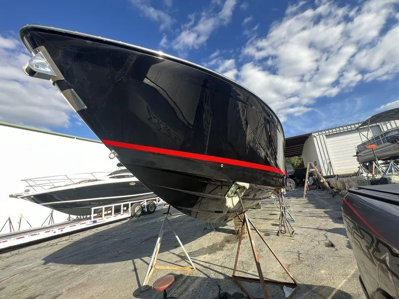 Slide: The Image of 2022 Formula 400 Super Sport Crossover boat on stands, under a clear blue sky. - 14