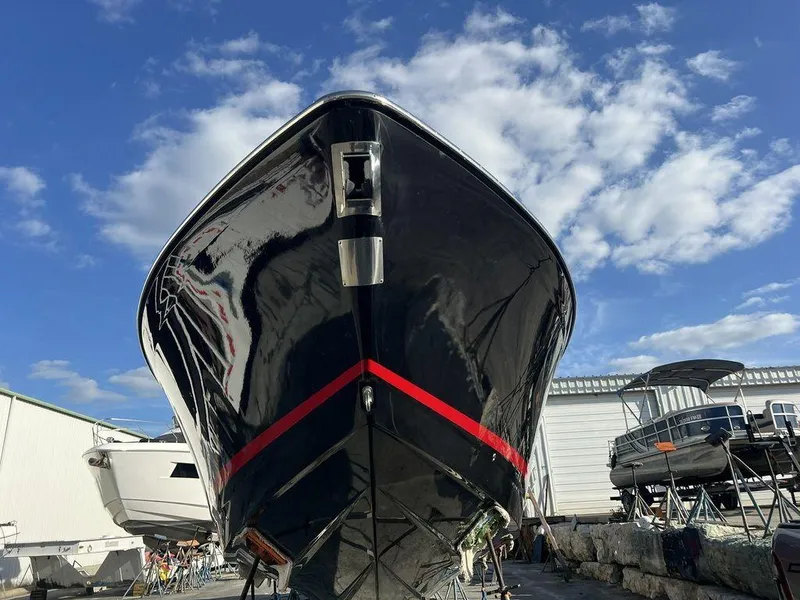 Slide: The Image of 2022 Formula 400 Super Sport Crossover boat, docked under a clear blue sky. - 15