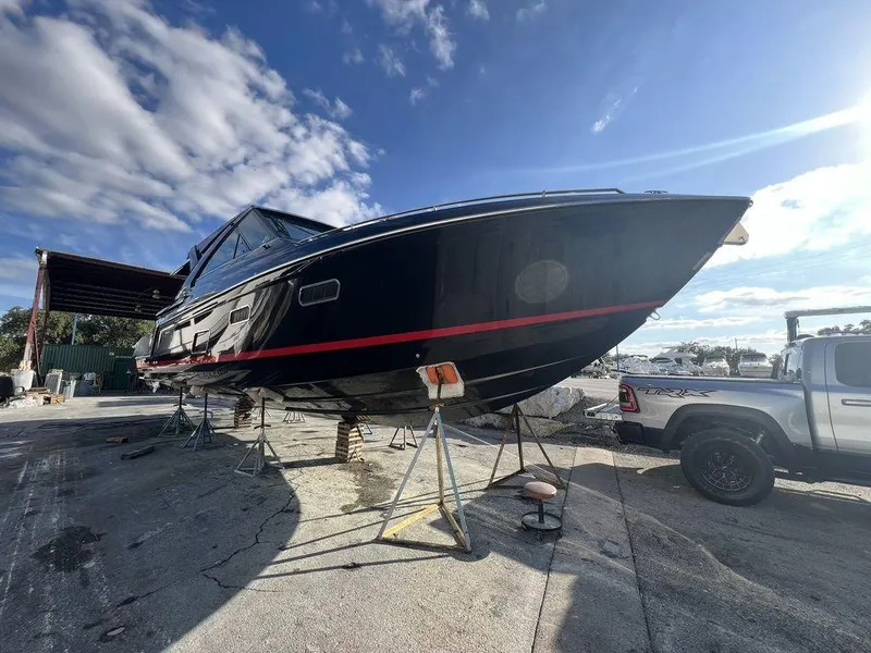 Slide: The Image of 2022 Formula 400 Super Sport Crossover boat on dry dock under a clear blue sky. - 18