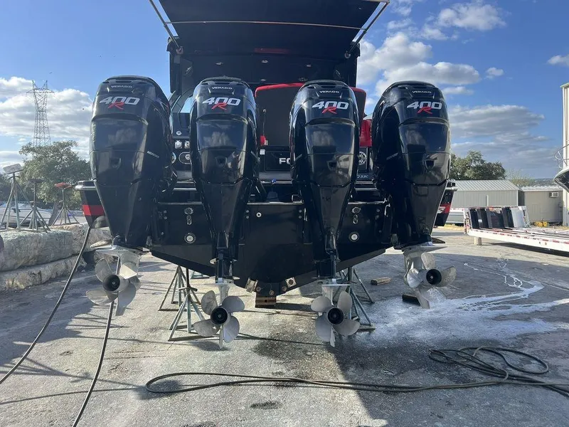 Slide: The Image of 2022 Formula 400 Super Sport Crossover with four powerful outboard engines, docked outdoors. - 21