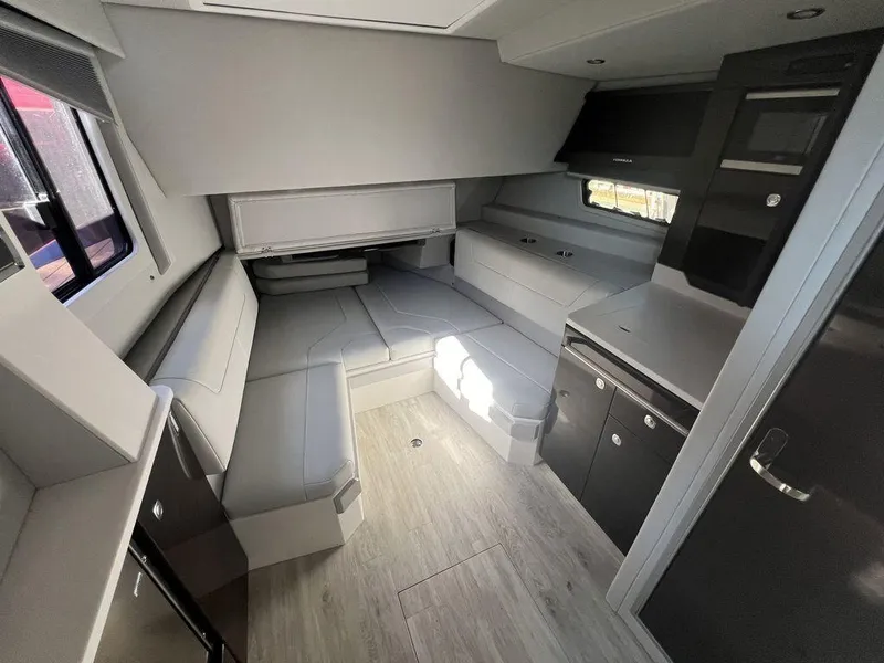 Slide: The Image of 2022 Formula 400 Super Sport Crossover interior with modern seating and cabinetry. - 46