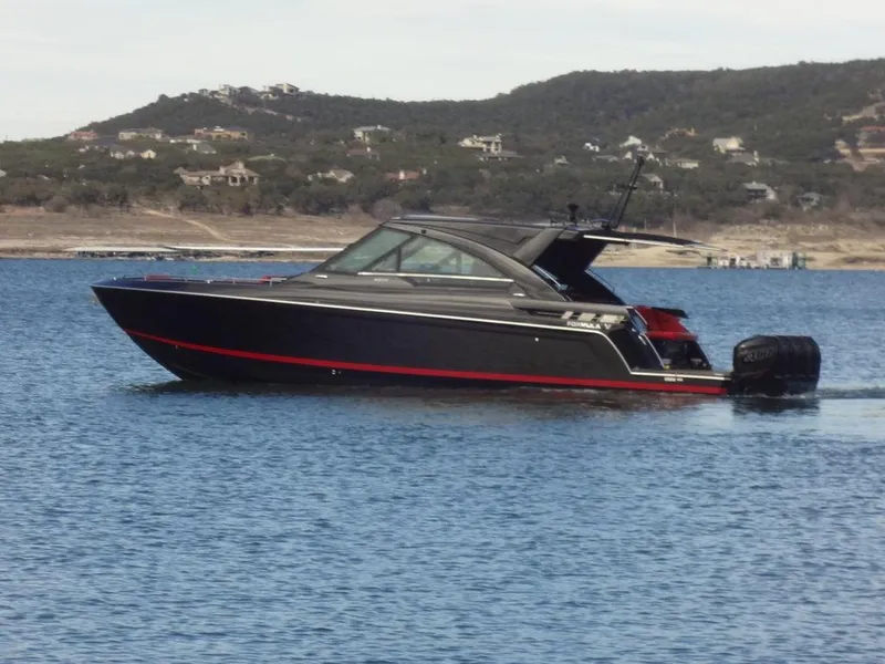 Slide: The Image of 2022 Formula 400 Super Sport Crossover boat on a serene lake with hills in the background. - 8