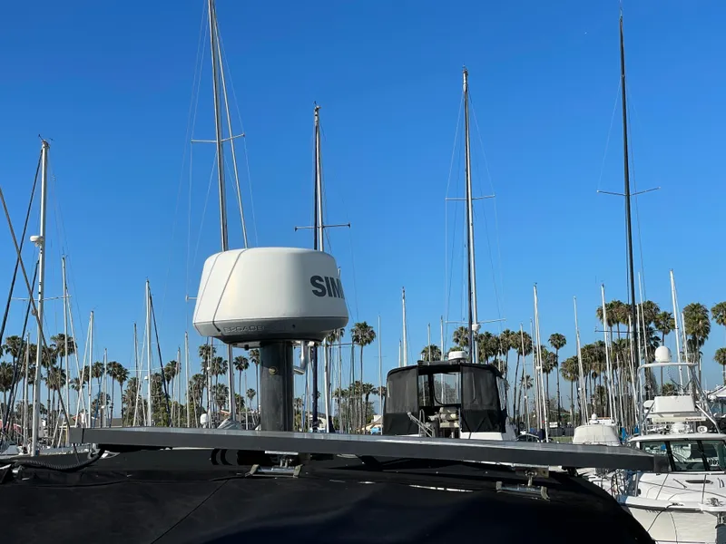 Slide: The Image of Sailboat marina with C&C 121, 2001 model, radar equipment, and palm trees under clear blue sky. - 21