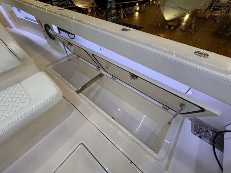 Slide: The Image of 2025 Solace 32 CS boat storage compartment with open hatch, showcasing interior space. - 15