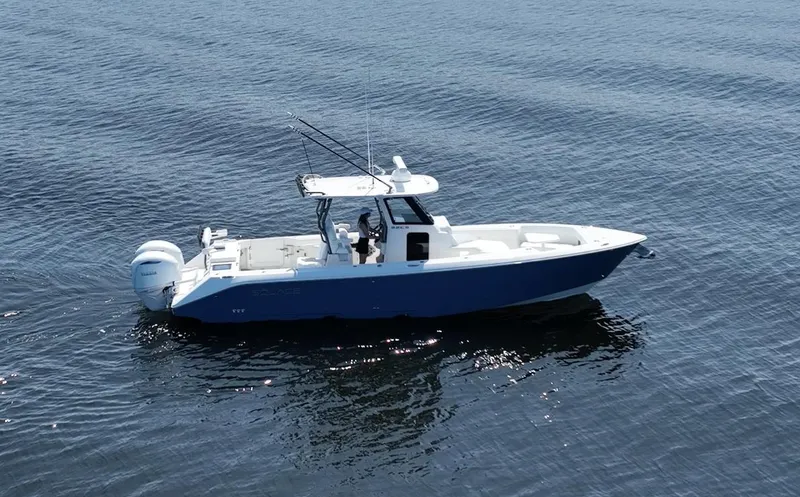 Slide: The Image of 2025 Solace 32 CS boat on calm water, side view. - 2