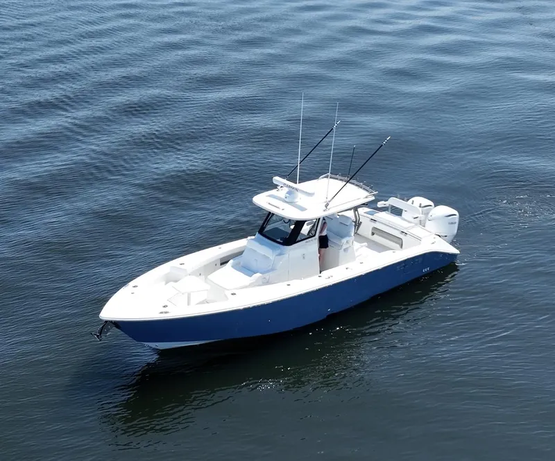 Slide: The Image of 2025 Solace 32 CS boat cruising on calm water. - 3