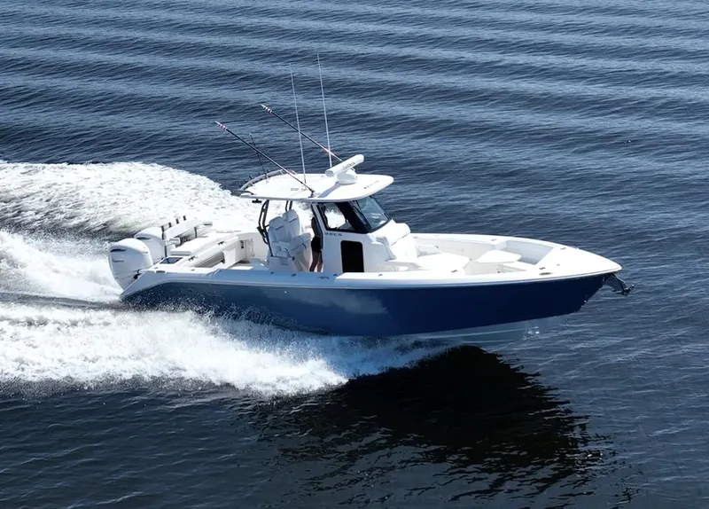 Slide: The Image of 2025 Solace 32 CS boat cruising on calm water, showcasing sleek design and performance. - 4