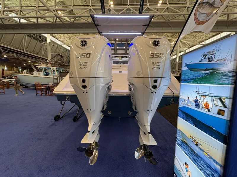 Slide: The Image of 2025 Solace 32 CS boat with twin 350 V8 engines at a boat show. - 7