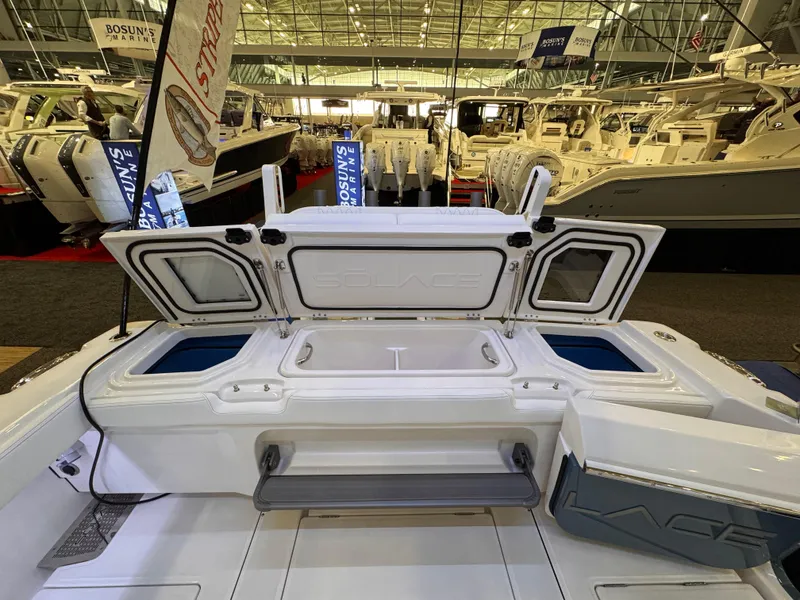 Slide: The Image of 2025 Solace 32 CS boat interior at a boat show, showcasing storage compartments. - 9