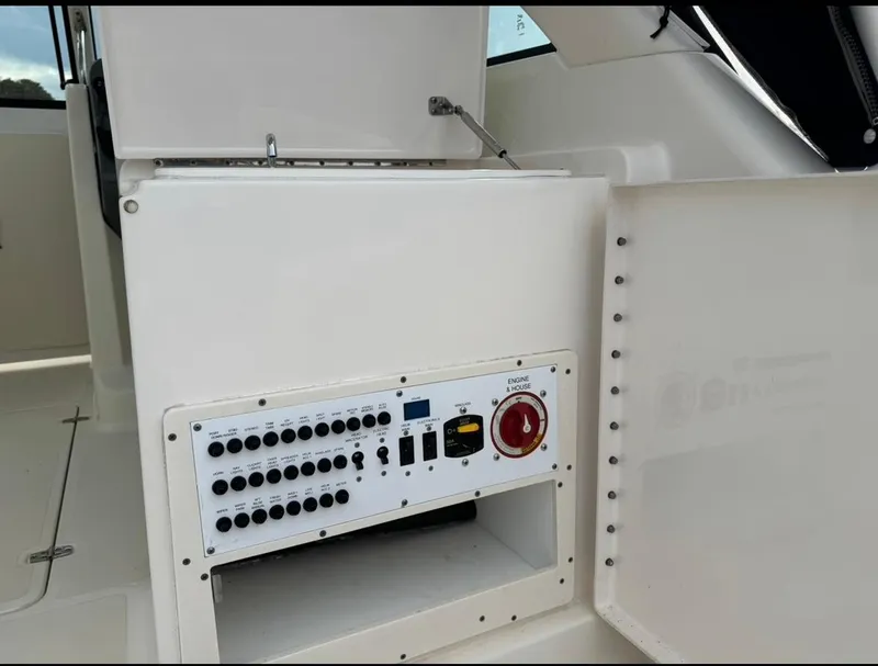 Slide: The Image of Control panel on a 2014 Pursuit DC 265 Dual Console boat interior. - 12