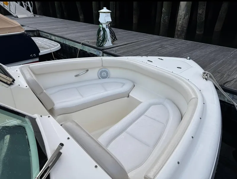 Slide: The Image of 2014 Pursuit DC 265 Dual Console boat with white seating at dock. - 20