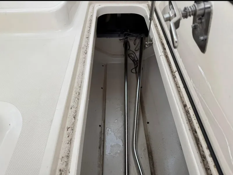 Slide: The Image of Storage compartment of a 2014 Pursuit DC 265 Dual Console boat. - 23