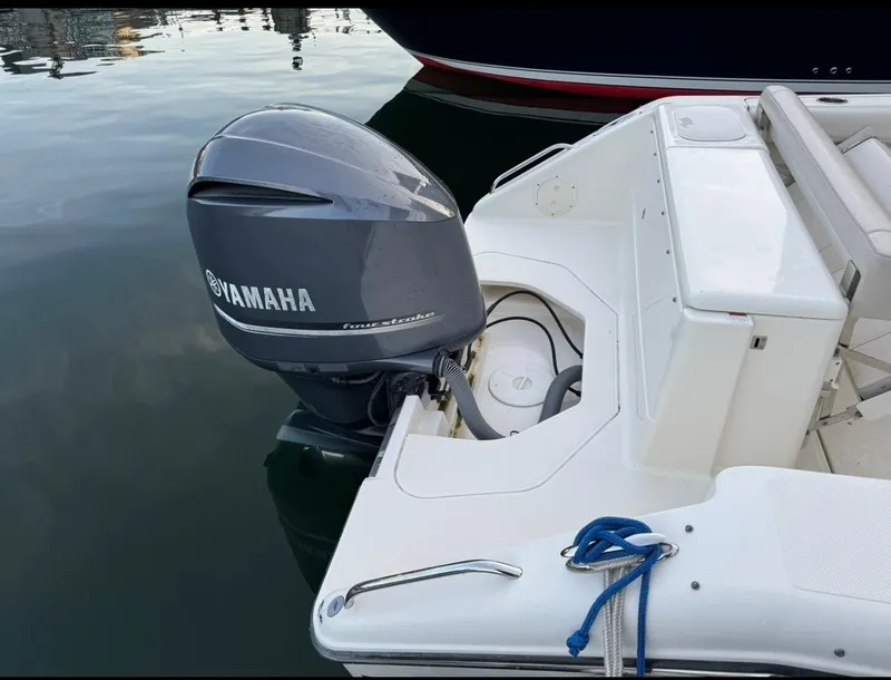 Slide: The Image of 2014 Pursuit DC 265 Dual Console with Yamaha outboard motor in marina. - 3