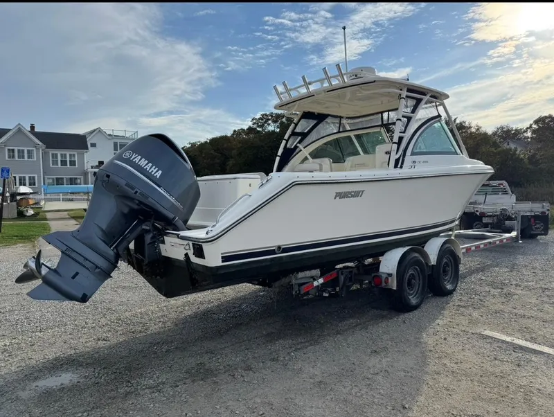 Slide: The Image of 2014 Pursuit DC 265 Dual Console boat on trailer with Yamaha outboard motor. - 30