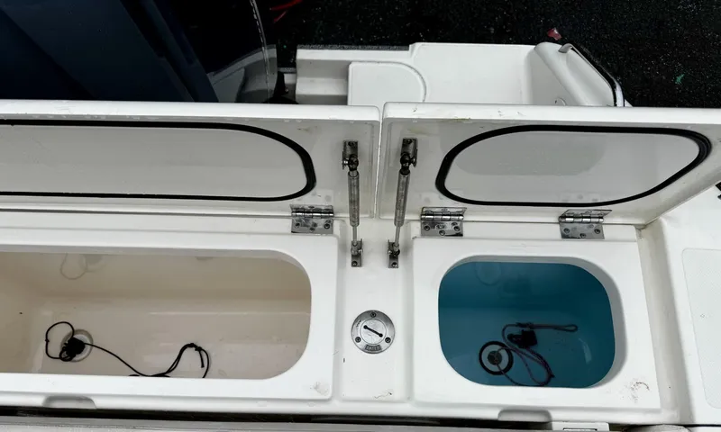 Slide: The Image of Open storage compartments on a 2014 Pursuit DC 265 Dual Console boat. - 4
