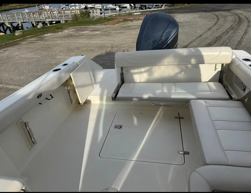 Slide: The Image of 2014 Pursuit DC 265 Dual Console boat interior with seating and storage. - 6