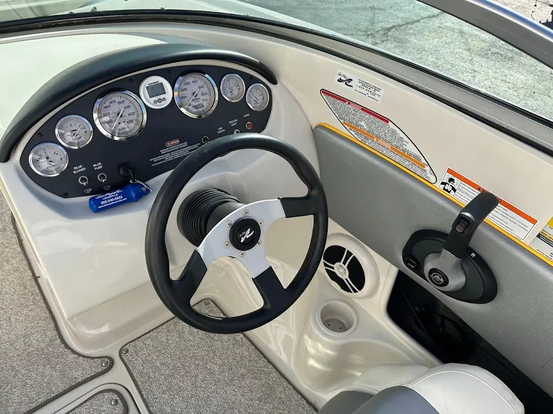 Slide: The Image of Dashboard of a 2008 Sea Ray 185 Sport boat with steering wheel and gauges. - 10
