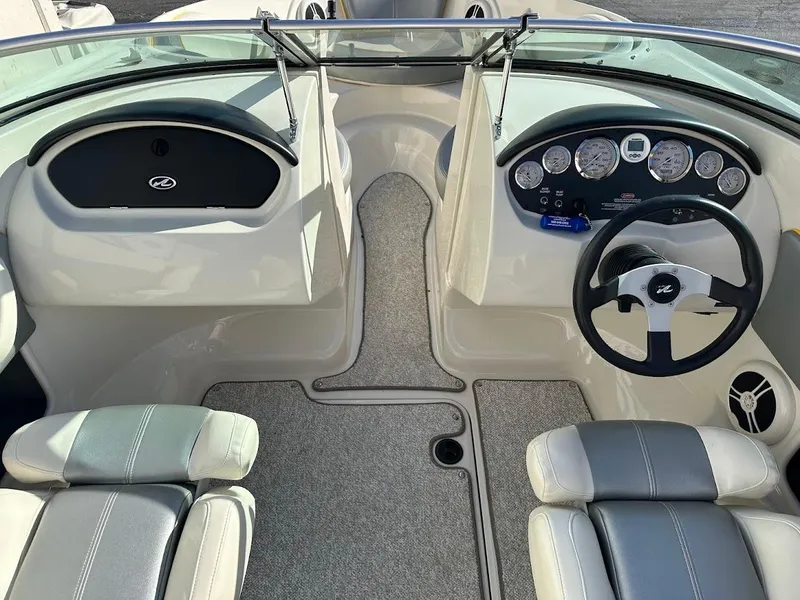 Slide: The Image of 2008 Sea Ray 185 Sport boat interior with steering wheel and dashboard controls. - 7