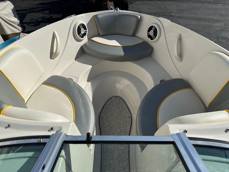 Slide: The Image of 2008 Sea Ray 185 Sport boat interior with cushioned seating and speakers. - 8