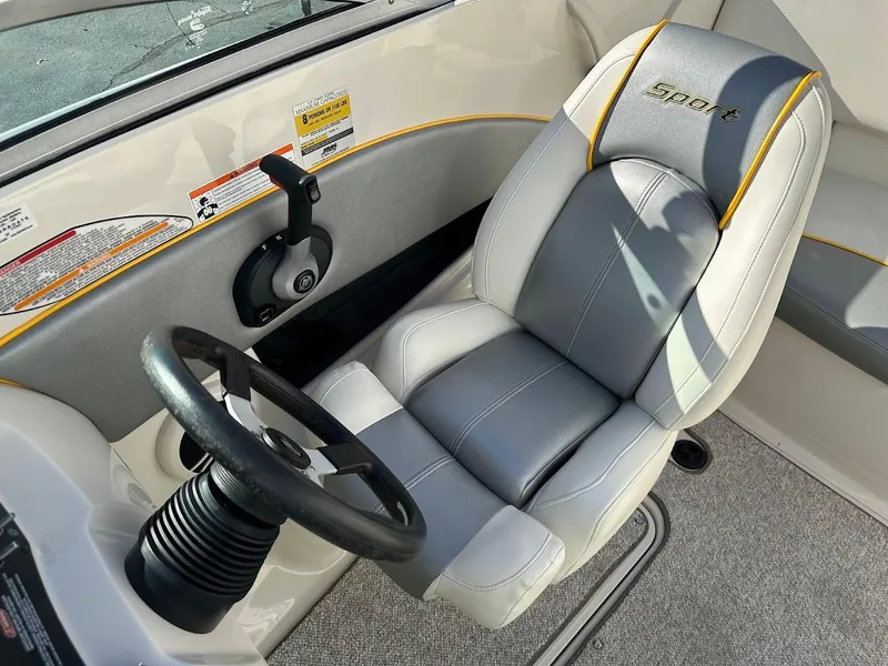 Slide: The Image of 2008 Sea Ray 185 Sport boat interior with steering wheel and cushioned seat. - 9