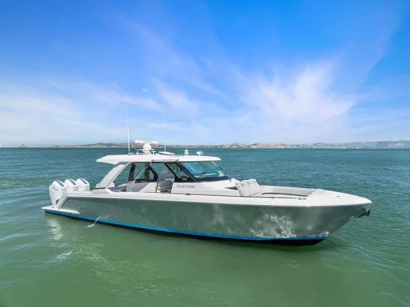 Slide: The Image of 2024 Tiara Yachts 48 LS cruising on calm blue waters. - 0