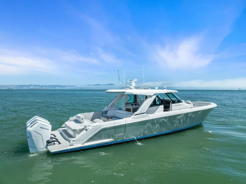 Slide: The Image of 2024 Tiara Yachts 48 LS luxury boat on open water. - 1