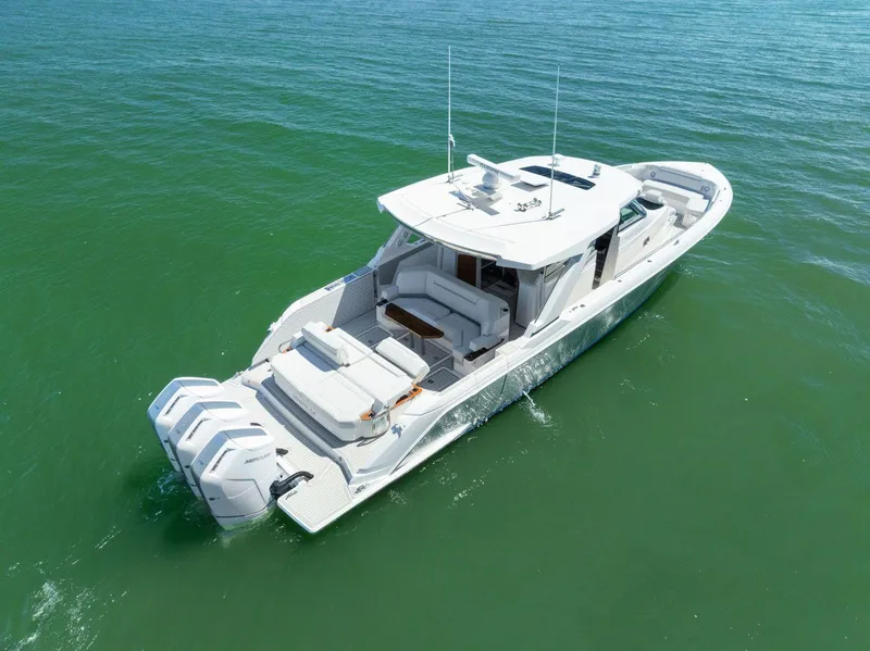 Slide: The Image of 2024 Tiara Yachts 48 LS cruising on calm green waters. - 10