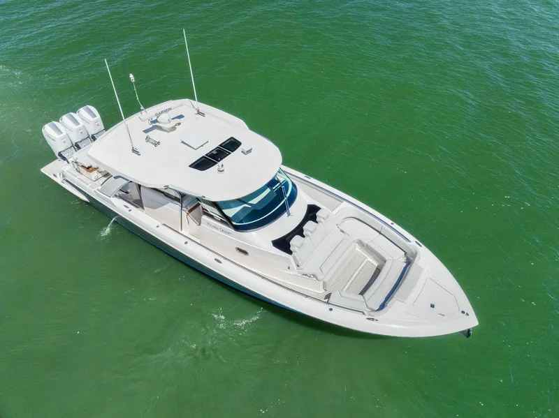 Slide: The Image of 2024 Tiara Yachts 48 LS luxury boat cruising on green water. - 11