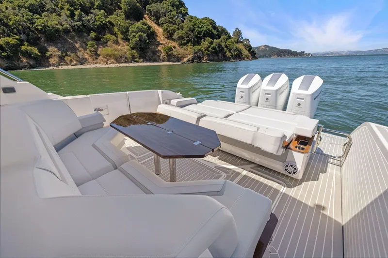 Slide: The Image of 2024 Tiara Yachts 48 LS luxury yacht with spacious seating and triple outboard engines. - 21