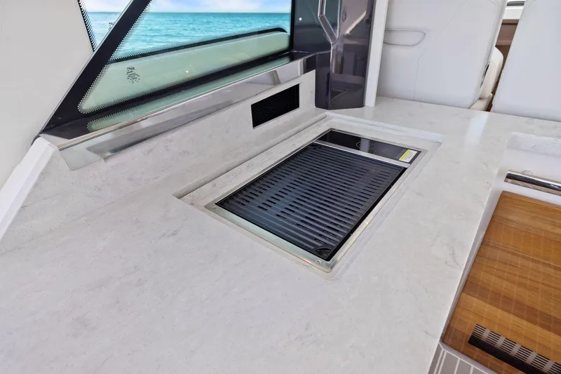 Slide: The Image of 2024 Tiara Yachts 48 LS interior with sleek countertop and built-in grill. - 25