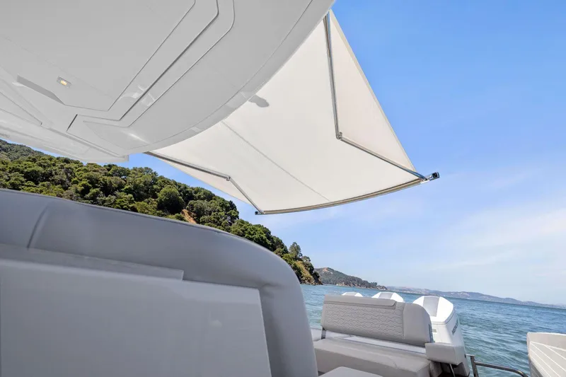 Slide: The Image of 2024 Tiara Yachts 48 LS with sunshade, scenic ocean view. - 27