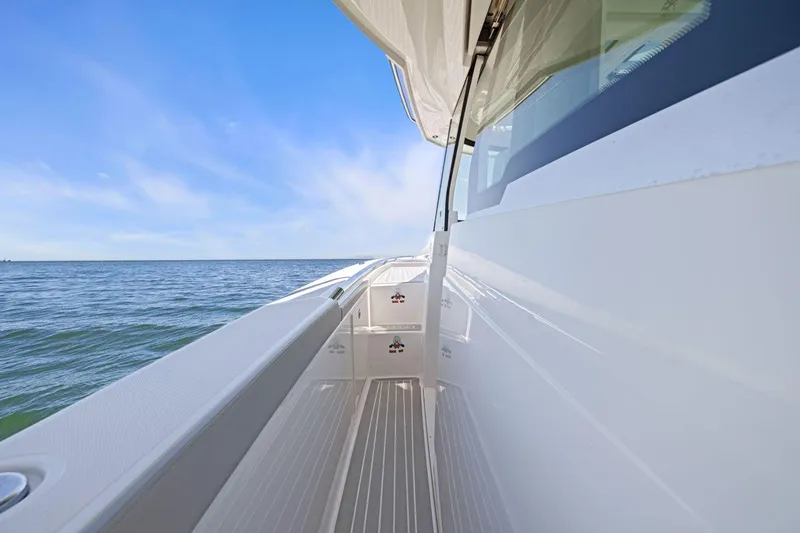 Slide: The Image of 2024 Tiara Yachts 48 LS side deck view with ocean backdrop. - 28