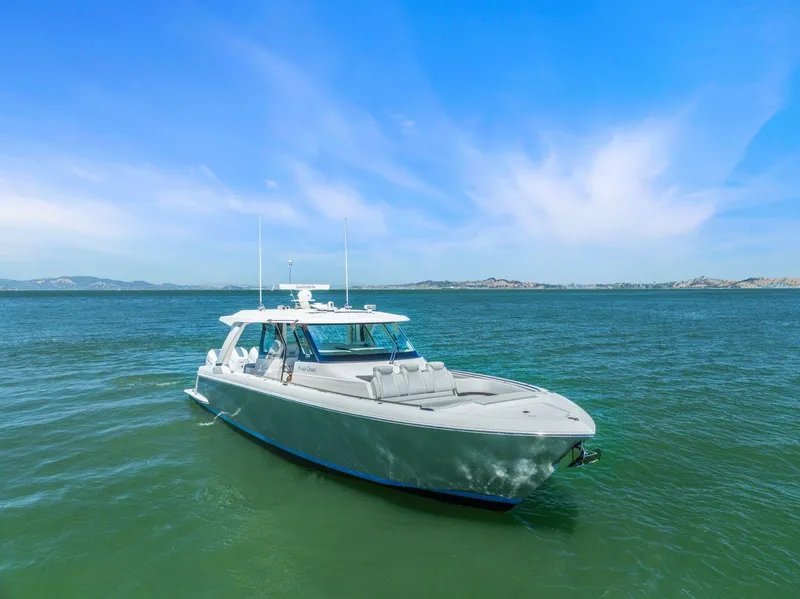 Slide: The Image of 2024 Tiara Yachts 48 LS cruising on a serene blue sea. - 3