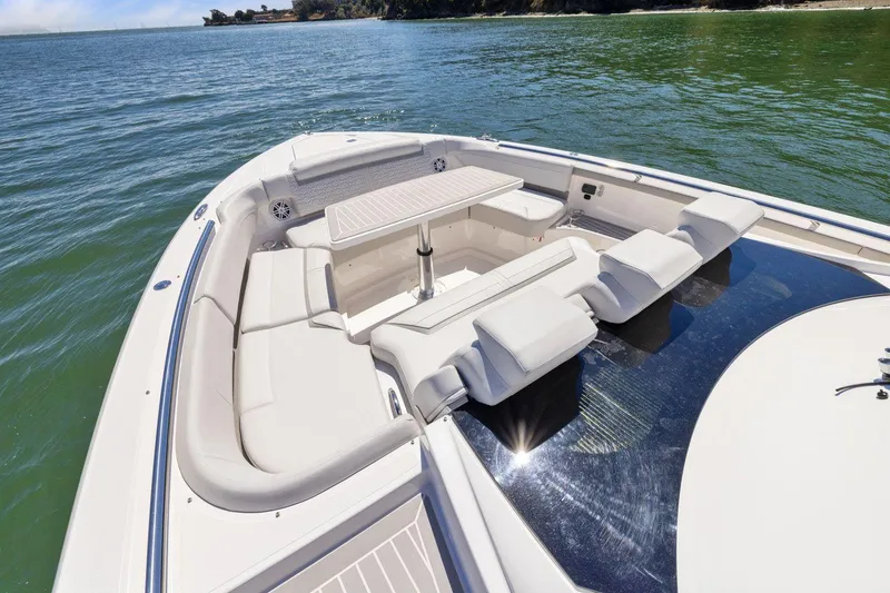 Slide: The Image of Luxurious 2024 Tiara Yachts 48 LS boat with spacious seating and table on calm water. - 32