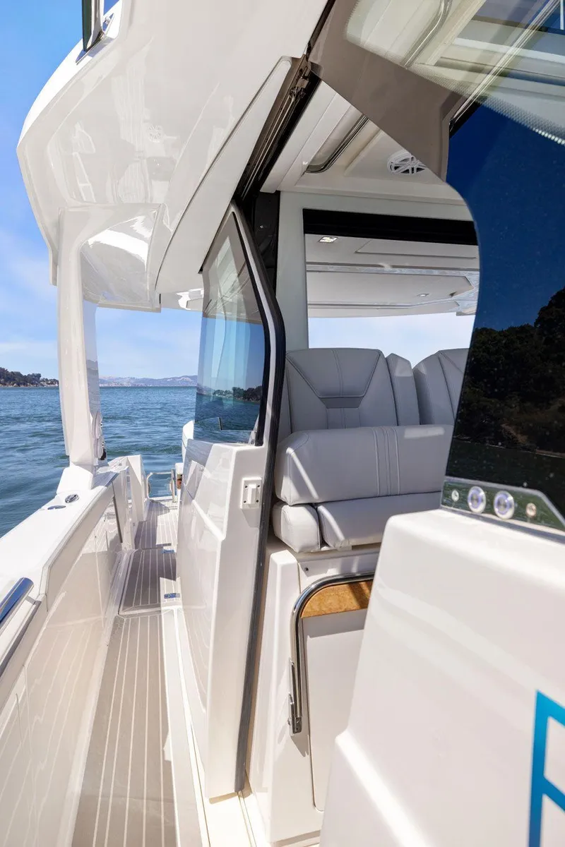 Slide: The Image of 2024 Tiara Yachts 48 LS luxury yacht interior with sleek design and waterfront view. - 34