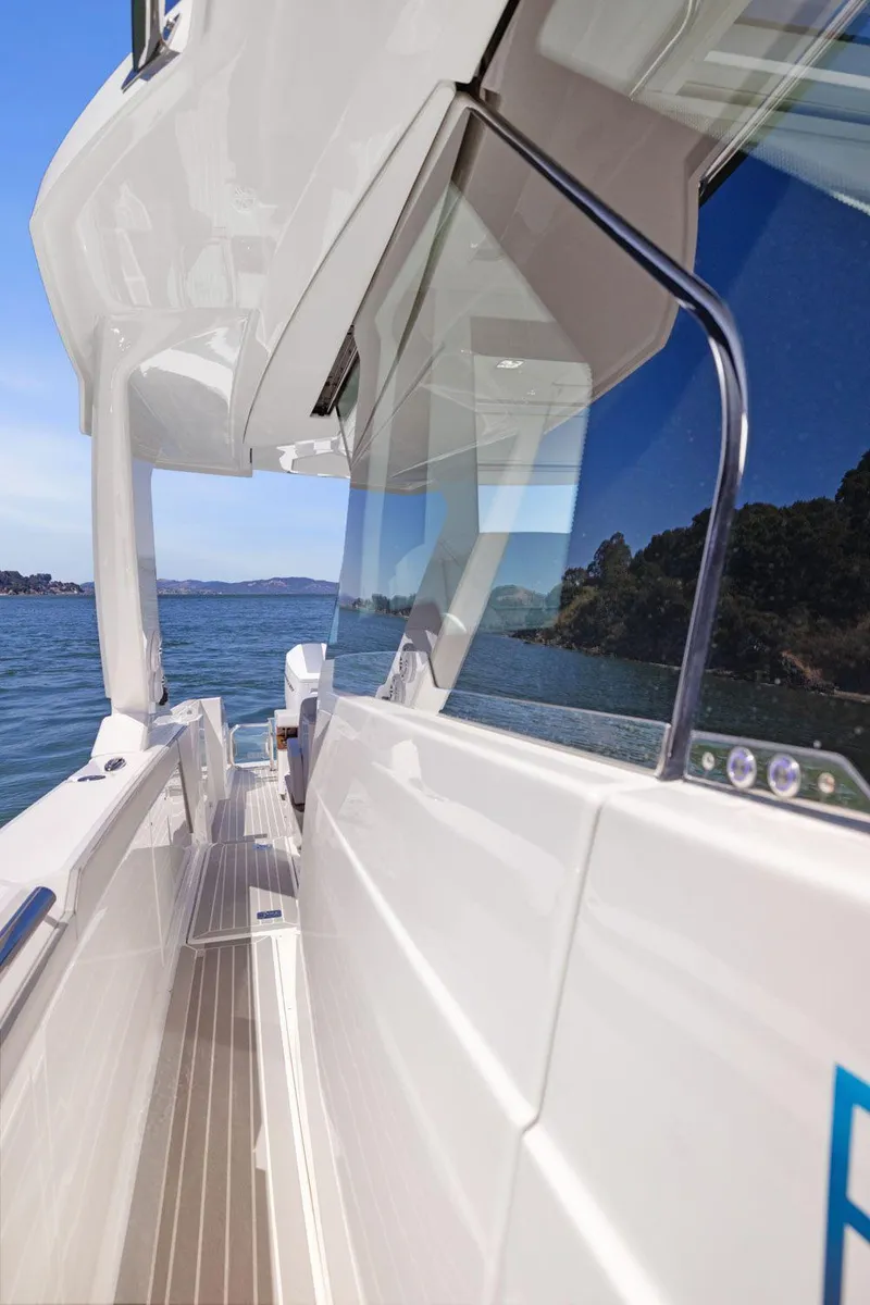 Slide: The Image of 2024 Tiara Yachts 48 LS, sleek design, side view on water. - 35