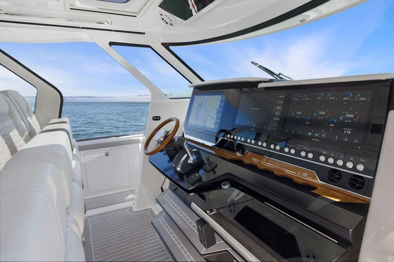 Slide: The Image of 2024 Tiara Yachts 48 LS helm with advanced navigation system and ocean view. - 36