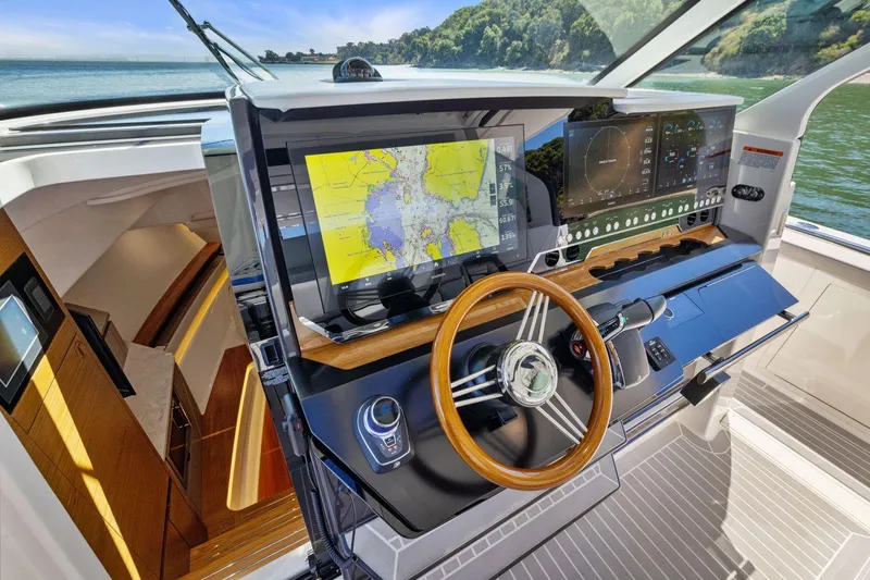 Slide: The Image of 2024 Tiara Yachts 48 LS helm with advanced navigation displays and luxurious interior. - 37