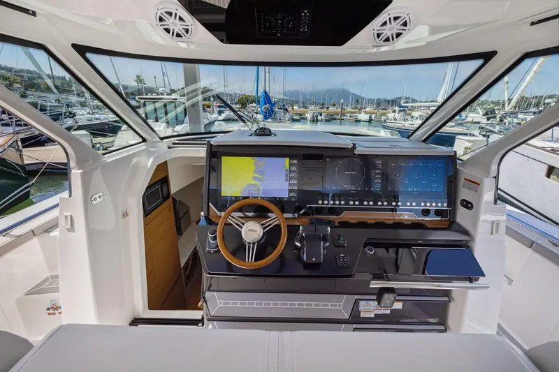 Slide: The Image of 2024 Tiara Yachts 48 LS helm with advanced navigation system and luxurious interior. - 40